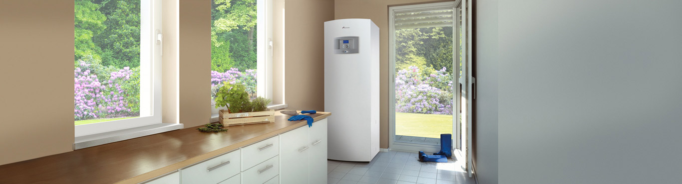 Photo of a kitchen with dirty boots at the door next to an understated heat pump.