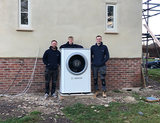 Simon Marsh with heat pump outside property